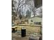 View of the backyard with a wooden fence, small shed, and deck with an outdoor grill and table at 801 N Denny St, Indianapolis, IN 46201