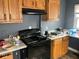 Kitchen with oak cabinets, and black appliances at 801 N Denny St, Indianapolis, IN 46201