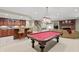 Finished basement with pool table, wet bar, and cozy seating area with a fireplace at 8027 Heyward Dr, Indianapolis, IN 46250