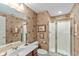 Cozy bathroom featuring patterned wallpaper, walk-in shower, and vanity with stylish mirror at 8027 Heyward Dr, Indianapolis, IN 46250