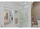 Elegant bathroom featuring a glass-enclosed shower, neutral tiling, and convenient access to a closet at 8027 Heyward Dr, Indianapolis, IN 46250