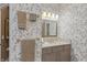 Charming bathroom with floral wallpaper, neutral vanity, stylish mirror, and beautiful gold towel racks at 8027 Heyward Dr, Indianapolis, IN 46250