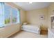 Bedroom with large window and sunny view, carpeted floors, and white wooden bed at 8027 Heyward Dr, Indianapolis, IN 46250