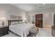 Cozy bedroom featuring carpeted floors, neutral walls, and a glimpse into the luxurious ensuite bathroom at 8027 Heyward Dr, Indianapolis, IN 46250