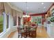 Breakfast nook with glass table and chairs, great view, and elegant lighting at 8027 Heyward Dr, Indianapolis, IN 46250