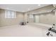 A bright home gym features large mirrors, natural light from windows, and ample open space at 8027 Heyward Dr, Indianapolis, IN 46250