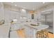 Bright, all-white kitchen featuring an island, granite countertops, and stainless steel appliances at 8027 Heyward Dr, Indianapolis, IN 46250