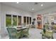 Bright sunroom with greenery views, wicker furniture, and tile flooring at 8027 Heyward Dr, Indianapolis, IN 46250
