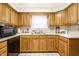 Traditional kitchen showcasing wood cabinets and a window over the sink at 8116 Heritage Commons Dr # Bldg 24, Indianapolis, IN 46219