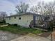 Rear view of the property featuring a small deck and a well kept yard at 8412 E 47Th St, Indianapolis, IN 46226