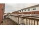 Spacious balcony with a wooden floor and railing, offering views of surrounding townhome exteriors at 861 S Park Trail Dr, Carmel, IN 46032