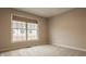 Comfortable bedroom with a large window providing ample natural light and neutral carpeting at 861 S Park Trail Dr, Carmel, IN 46032