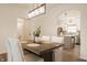Bright dining room boasts modern chandelier and flows into kitchen, creating inviting and open space at 861 S Park Trail Dr, Carmel, IN 46032