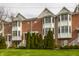Classic brick townhome exterior with well-maintained lawn and greenery, showcasing timeless curb appeal at 861 S Park Trail Dr, Carmel, IN 46032