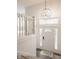 Welcoming foyer featuring a stylish chandelier, white staircase, and bright entryway with a decorative rug at 861 S Park Trail Dr, Carmel, IN 46032