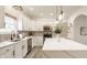 Modern kitchen features white cabinets, stainless steel appliances, and expansive island with stylish pendant lighting at 861 S Park Trail Dr, Carmel, IN 46032