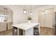 This modern kitchen boasts a large island with bar stool and features stainless steel appliances with stylish pendant lighting at 861 S Park Trail Dr, Carmel, IN 46032