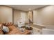Spacious living room featuring a brown leather sofa, two comfortable armchairs, and an open staircase at 861 S Park Trail Dr, Carmel, IN 46032