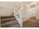 Bright foyer with a staircase, modern lighting, and wood flooring, creating a welcoming entrance at 861 S Park Trail Dr, Carmel, IN 46032