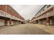 View of brick townhomes with garages and balcony spaces; car parking and neutral color palette at 861 S Park Trail Dr, Carmel, IN 46032