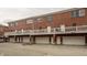 Brick townhome facade showcasing attached garages, private balconies, and classic architectural features at 861 S Park Trail Dr, Carmel, IN 46032
