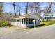 Charming home with grey siding, screened porch, and mature trees at 8644 S Kinman Dr, , IN 46164