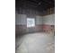 A bedroom under construction has exposed insulation and partially finished walls next to a window at 1016 Dawson St, Indianapolis, IN 46203