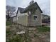 Side view of home featuring newly installed gray siding and new white trim at 1016 Dawson St, Indianapolis, IN 46203