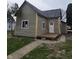 A charming home exterior showcases a new gray roof and light green siding at 1016 Dawson St, Indianapolis, IN 46203