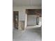 A partially drywalled living room shows exposed framing with visible electrical wiring and a door at 1016 Dawson St, Indianapolis, IN 46203