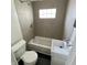 This bathroom features a tub, toilet, and sink with modern fixtures and lighting at 1020 N Colorado Ave, Indianapolis, IN 46201