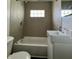 The bathroom features a tub, toilet, and sink with modern fixtures and lighting at 1020 N Colorado Ave, Indianapolis, IN 46201