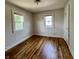 Inviting bedroom featuring hardwood floors, two windows, and neutral walls at 1020 N Colorado Ave, Indianapolis, IN 46201