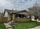 Charming single-story home with a brick porch and a well-maintained front yard, complemented by a mature tree at 1020 N Colorado Ave, Indianapolis, IN 46201