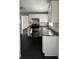 Functional kitchen with stainless steel appliances, white cabinets, and laminate countertops at 1020 N Colorado Ave, Indianapolis, IN 46201
