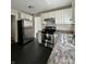 Well-lit kitchen featuring stainless steel appliances, white cabinetry, and a view into an adjacent room at 1020 N Colorado Ave, Indianapolis, IN 46201