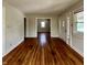 Inviting living room showcasing beautiful hardwood floors, neutral paint, and an open doorway to another room at 1020 N Colorado Ave, Indianapolis, IN 46201