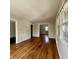 Open-concept living room with hardwood floors, large windows, and access to other rooms at 1020 N Colorado Ave, Indianapolis, IN 46201
