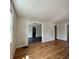 Spacious living room with hardwood flooring, neutral walls, and a glimpse into the kitchen at 1020 N Colorado Ave, Indianapolis, IN 46201