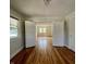 Bright living room featuring hardwood floors, white trim, and natural light streaming through the windows at 1020 N Colorado Ave, Indianapolis, IN 46201