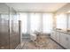 Spacious bathroom features a glass shower, vanity and makeup table at 1099 Valentine Ln, Carmel, IN 46032