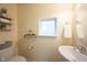 Bright powder room featuring a decorative shelf and window at 1099 Valentine Ln, Carmel, IN 46032
