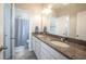 Bright bathroom with double sink vanity and granite countertops and a shower at 1099 Valentine Ln, Carmel, IN 46032