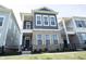 Stately home with a covered porch, brick accents, and a well-manicured lawn at 1099 Valentine Ln, Carmel, IN 46032