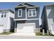 A well-maintained two-story home showcases a garage, siding, and well-kept landscaping at 1099 Valentine Ln, Carmel, IN 46032