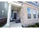 Charming front porch featuring a brick facade, stylish seating, and a welcoming entrance at 1099 Valentine Ln, Carmel, IN 46032