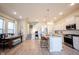 A modern kitchen is equipped with stainless steel appliances, white cabinetry, and an island with barstool seating at 1099 Valentine Ln, Carmel, IN 46032