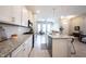 Open-concept kitchen with white cabinets, granite countertops, stainless steel appliances, and hardwood floors at 1099 Valentine Ln, Carmel, IN 46032