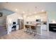 Modern kitchen with white cabinets, stainless steel appliances, and an island with seating, connecting to the rest of the house at 1099 Valentine Ln, Carmel, IN 46032