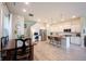 Bright, open-concept kitchen featuring white cabinets, stainless appliances, and an adjacent dining area with wooden table at 1099 Valentine Ln, Carmel, IN 46032
